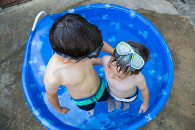 High angle view of boy playing in swimming pool