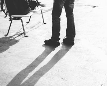 Low section of man standing on footpath