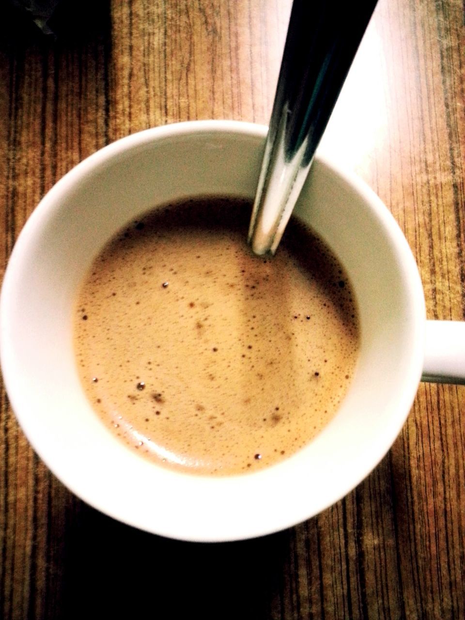 food and drink, drink, coffee cup, indoors, table, refreshment, saucer, coffee - drink, freshness, coffee, still life, cup, spoon, high angle view, close-up, frothy drink, directly above, beverage, healthy eating, cappuccino