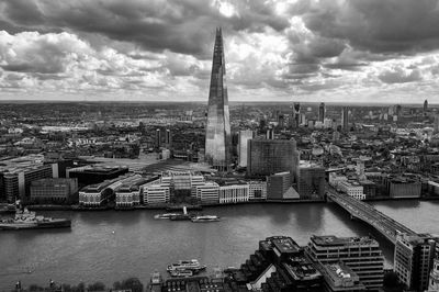 High angle view of buildings against cloudy sky