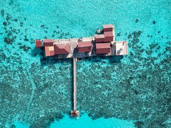 Aerial view of a tropical island in turquoise water.