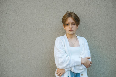 In her portrait, a teenage girl with short red hair reflects a mix of innocence and individuality