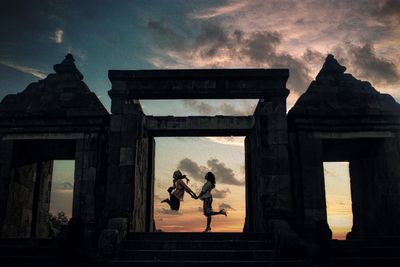Statue against sky at sunset