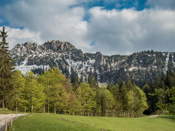 Scenic view of mountains against cloudy sky