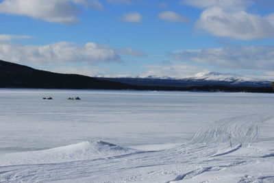 Scenic view of frozen lake against sky