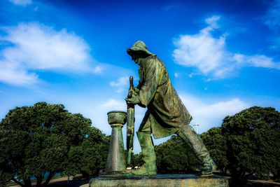 Low angle view of statue against cloudy sky