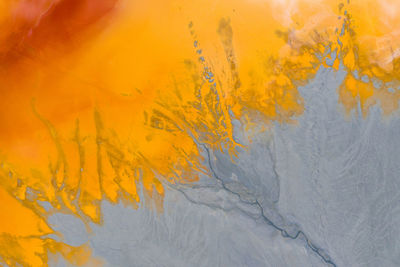 Colorful lake polluted with yellow waste water, aerial view of a mining decanting pond 