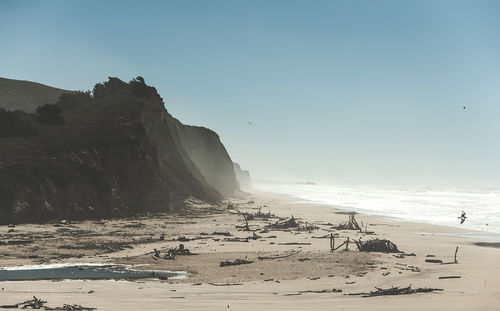 Scenic view of beach against clear sky