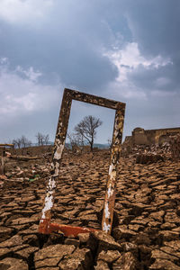 Low angle view of old ruin on field against sky