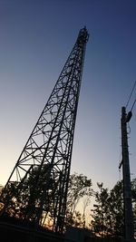 Low angle view of silhouette built structure against blue sky