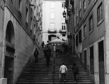 People walking on alley in city