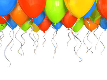 Multi colored balloons against white background