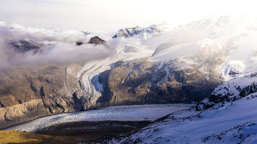 Scenic view of snow covered mountains against sky