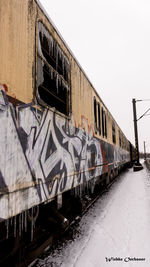 Train on railroad tracks against clear sky