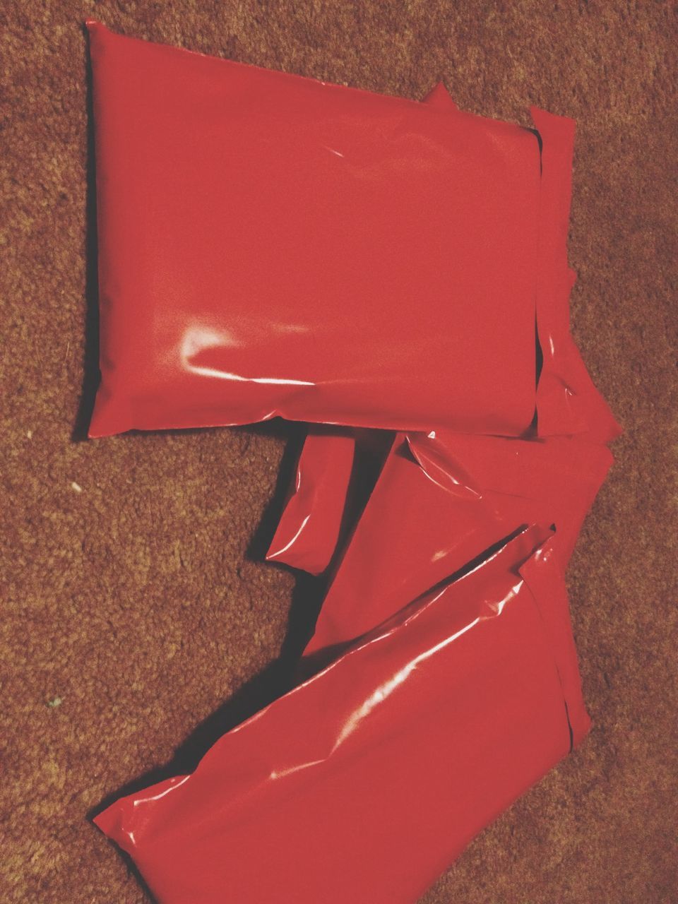 red, still life, high angle view, absence, no people, close-up, empty, chair, table, day, plastic, sand, single object, outdoors, sunlight, shadow, wall - building feature, seat, two objects