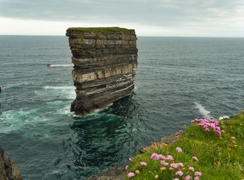 Motorboat passing  behind downpatrick head. 