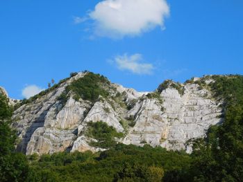 Scenic view of mountains against cloudy sky