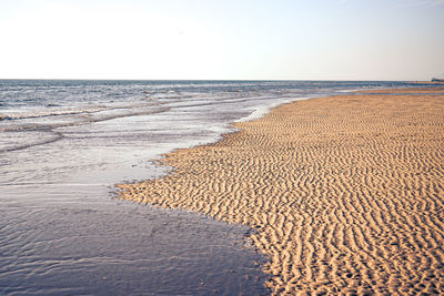 Scenic view of beach against clear sky