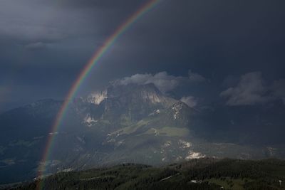 Rainbow over mountain against sky