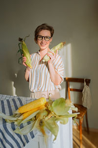 Young woman holding food on table