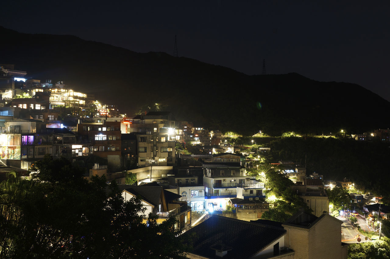 HIGH ANGLE VIEW OF ILLUMINATED BUILDINGS IN TOWN