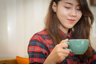 Young woman drinking coffee cup