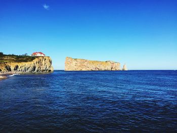 Scenic view of sea against clear blue sky