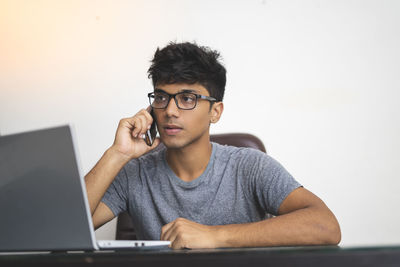 Portrait of young man using mobile phone