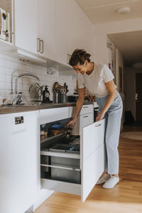 Woman putting waste in bin