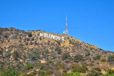 Low angle view of hollywood sign against clear blue sky