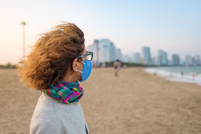 Side view of woman standing on beach
