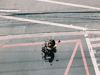 High angle view of man with philippines flag riding bicycle on road