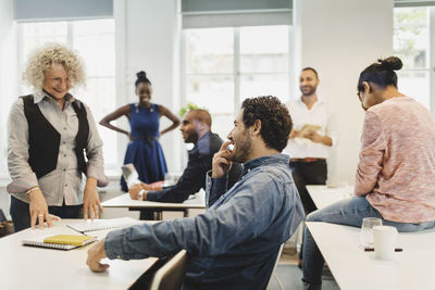 Students and teacher laughing in language class