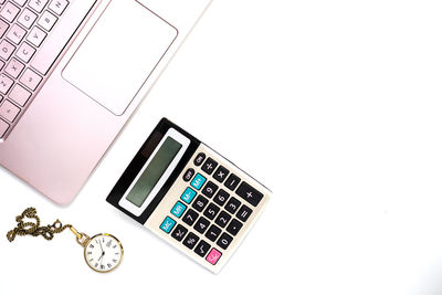 High angle view of laptop on table against white background