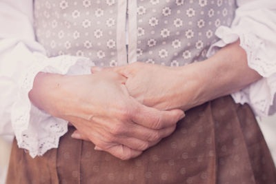 Midsection of couple holding hands