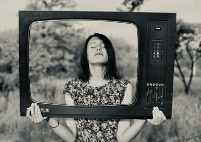 Portrait of woman standing against the wall