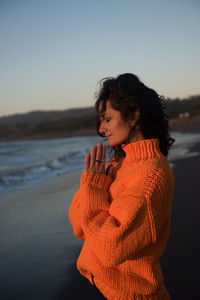 Peaceful woman takes in the view at sunset