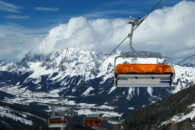 Ski lifts hanging over snowcapped mountains