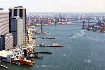 High angle view of river by buildings against sky