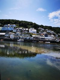 Town by lake in city against sky