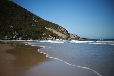 Scenic view of sea against clear blue sky