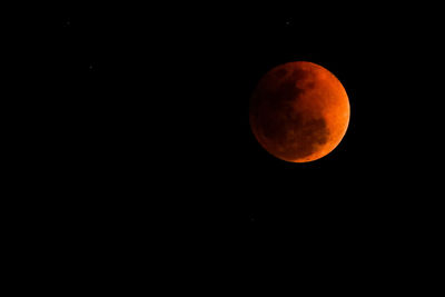 Low angle view of moon against clear sky at night