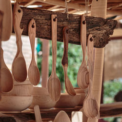 Close-up of wooden spatula hanging for sale