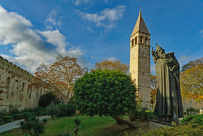 Panoramic view of trees and building against sky