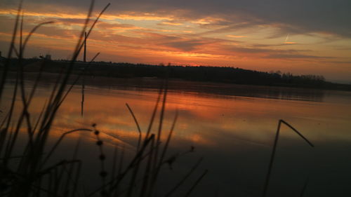 Scenic view of lake against sky during sunset