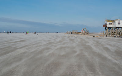 People on beach against sky