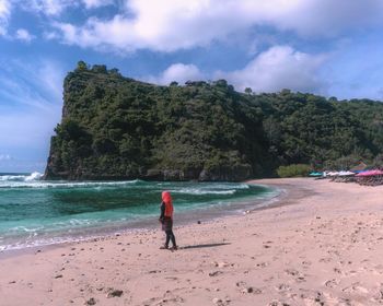 Full length of man on beach against sky