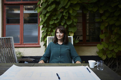 Full length of woman sitting on table