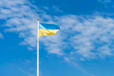 Low angle view of flag against sky