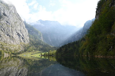 Scenic view of lake and mountains against sky